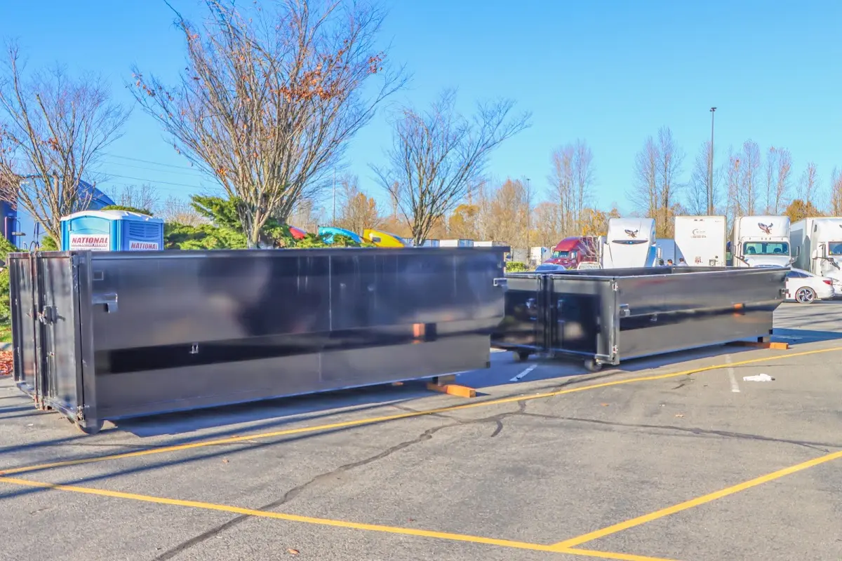 Professional dumpster rental service with roll-off container on residential driveway in Emerson